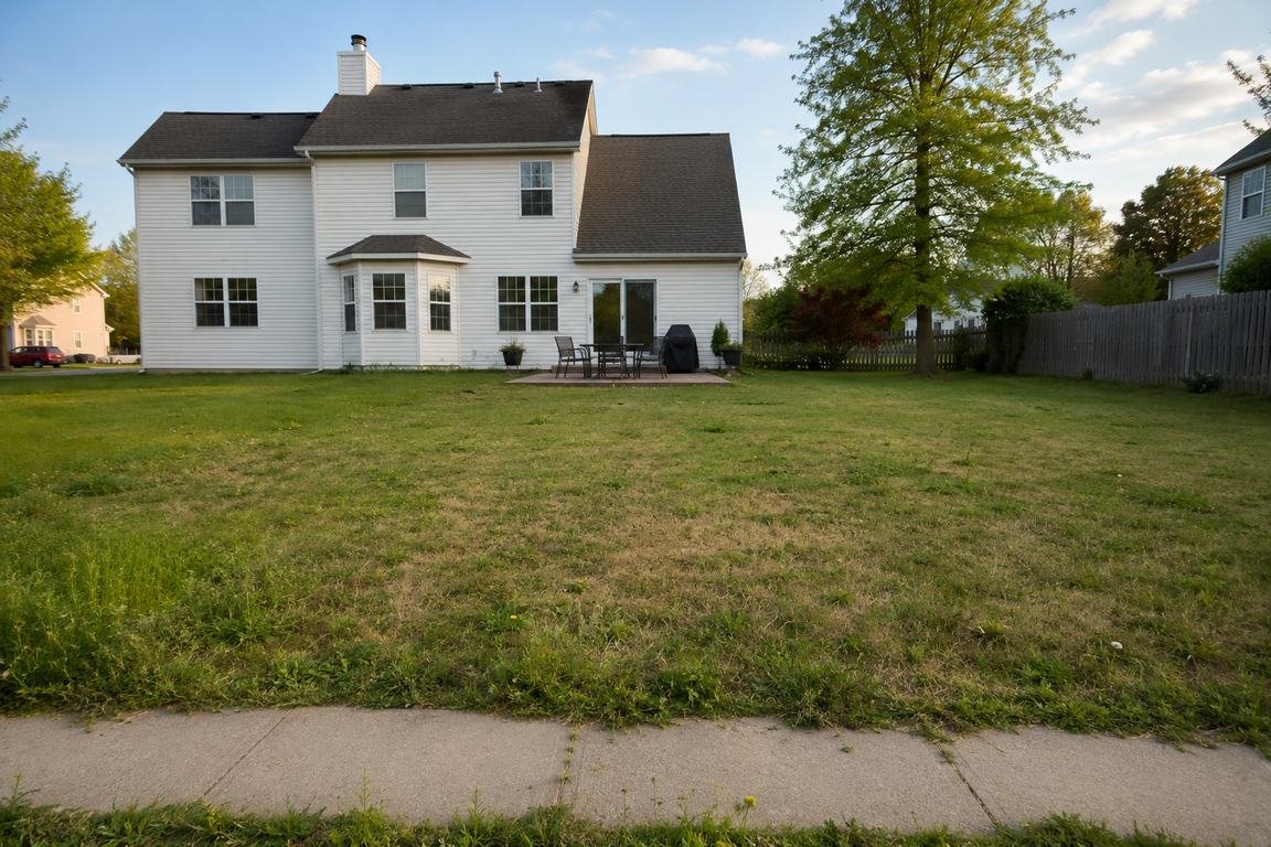 Design concept: lawn renewal and bed refresh, before — dry, uneven lawn with bare foundation beds